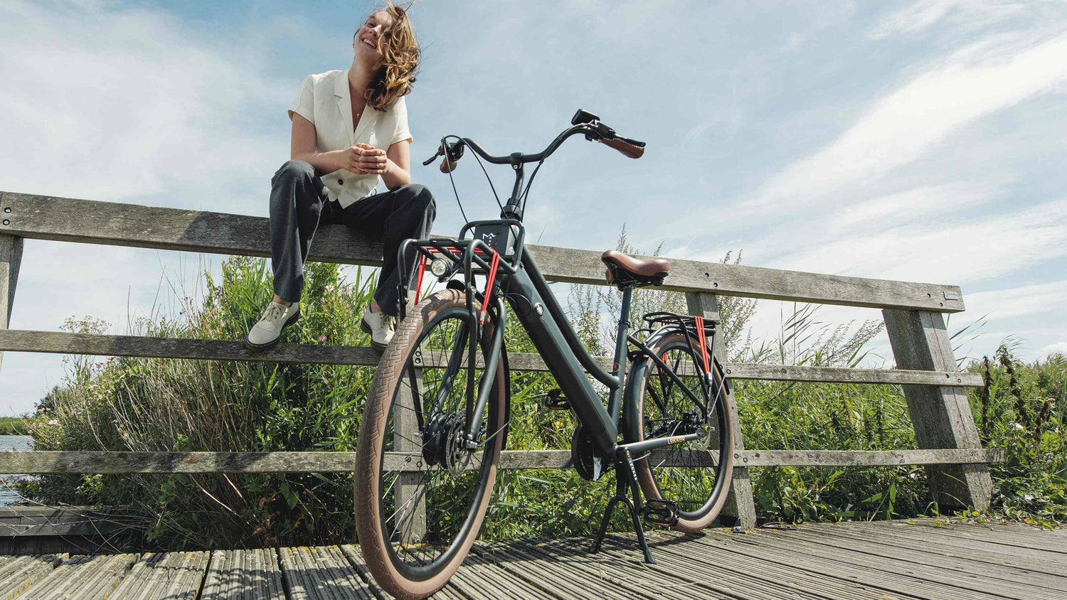 Woman with Dutch style Jordaan GT black ebike Woman with Dutch style Jordaan GT black ebike