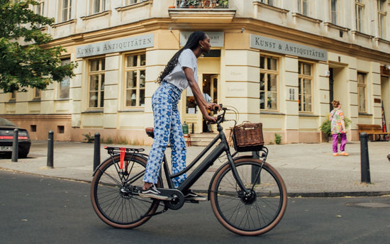 Woman on her electric bike Jordaan plus in the city